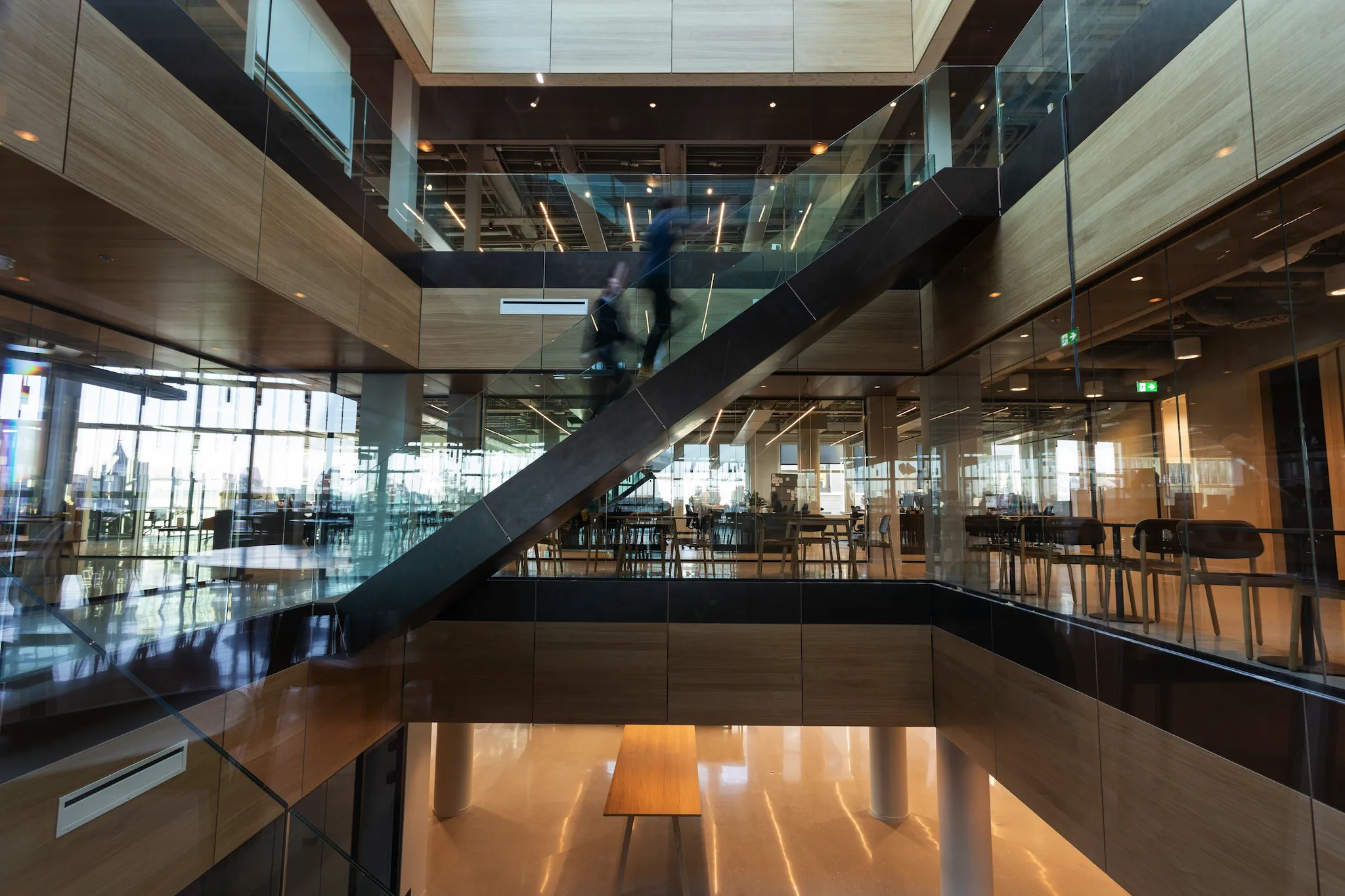 Image of a large office space with wooden stairs in the middle